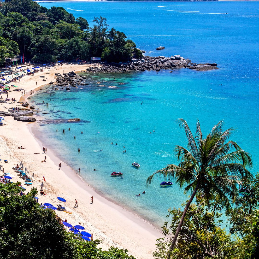 Laem Singh Beach, Phuket, a palm-fringed cove framed by granite boulders