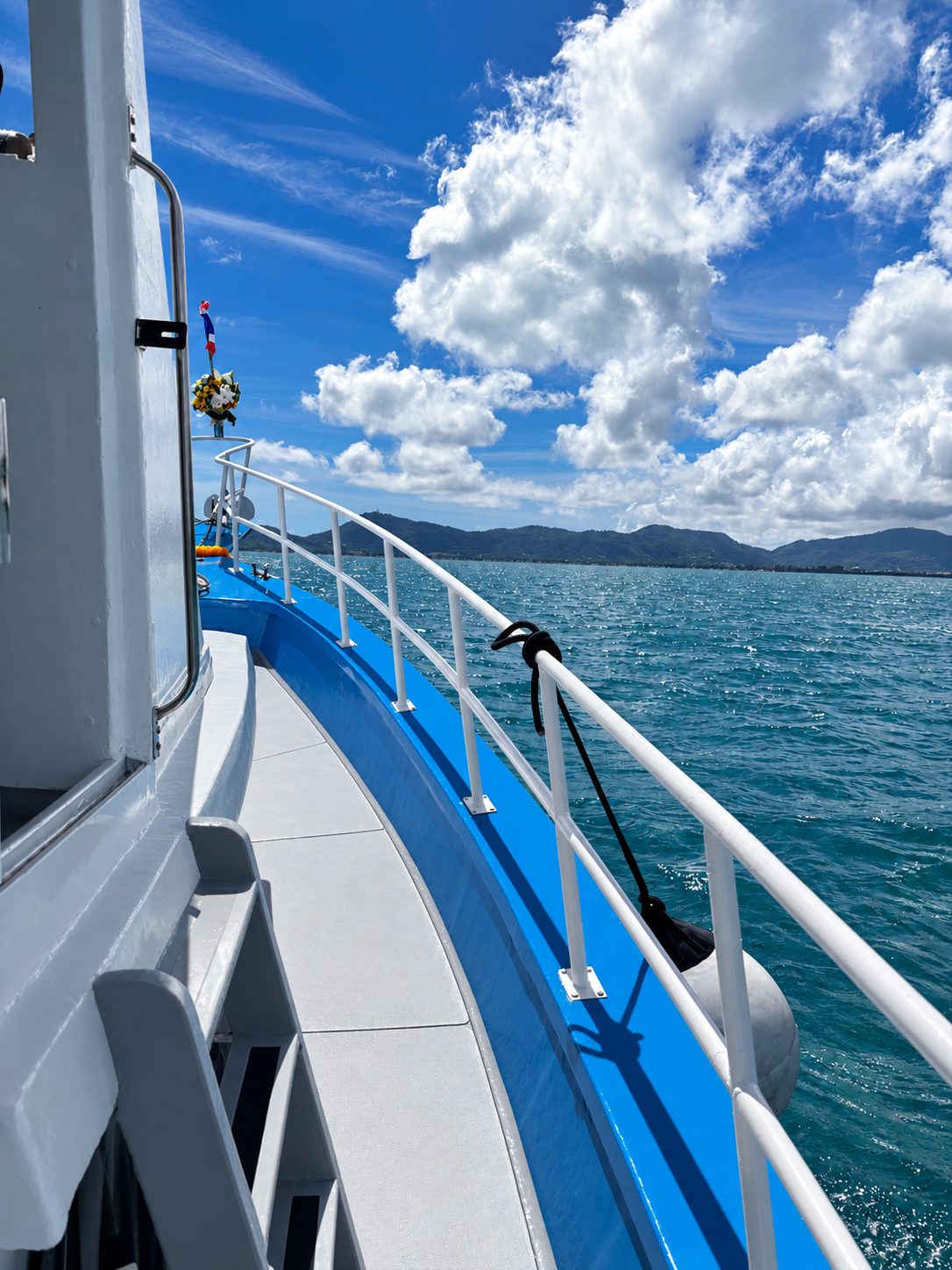 The starboard side deck looking forward, big clouds over the islands