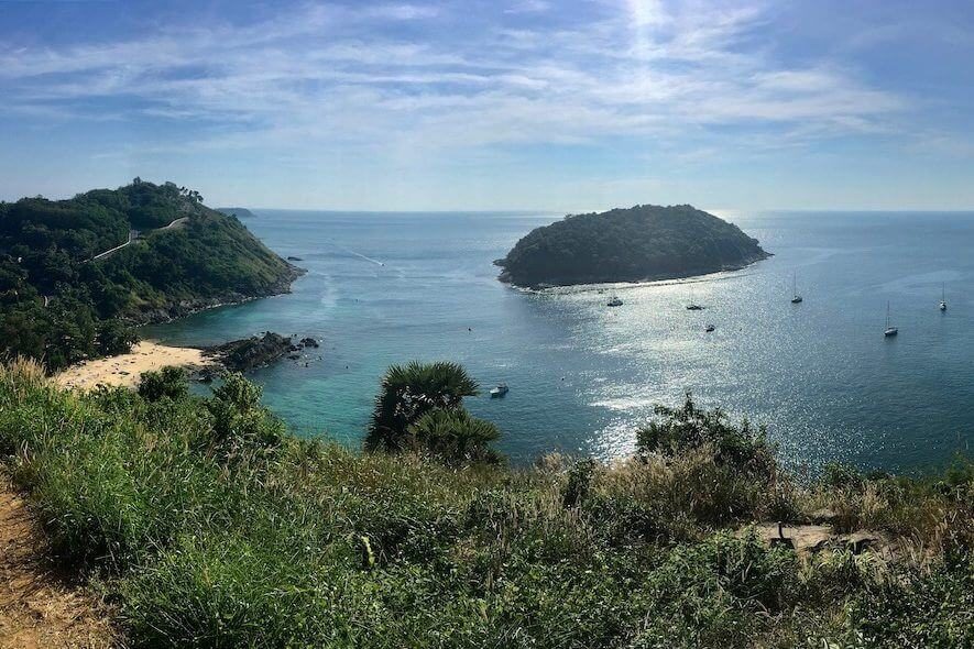 A bay with a rocky islet offshore, seen from a headland