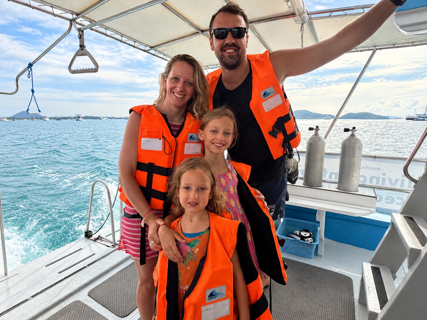 A family in life jackets on the sun deck of MV Matchanu