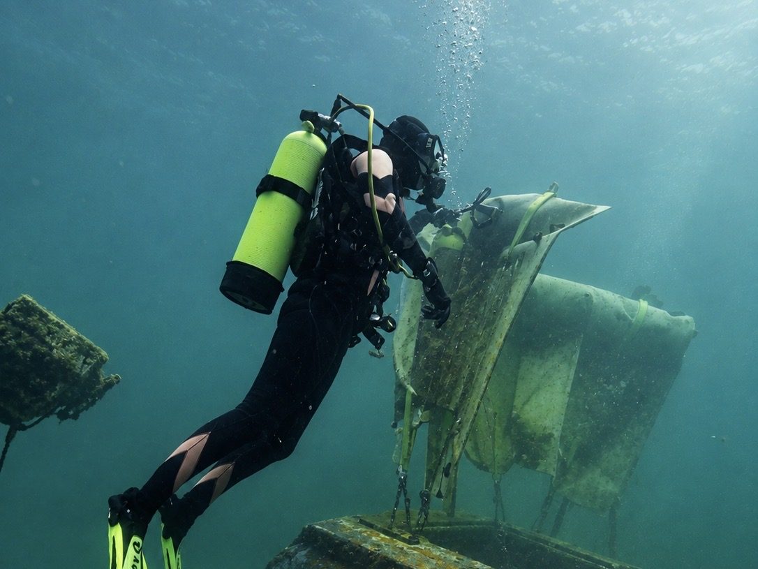 A diver lifting an object with a lift bag (PADI)