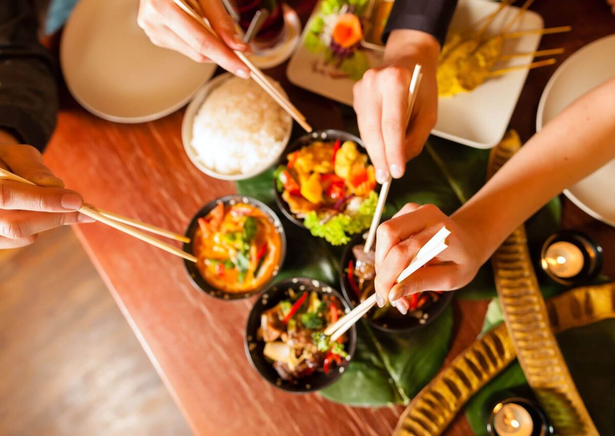 Thai dishes laid out on the boat table between dives