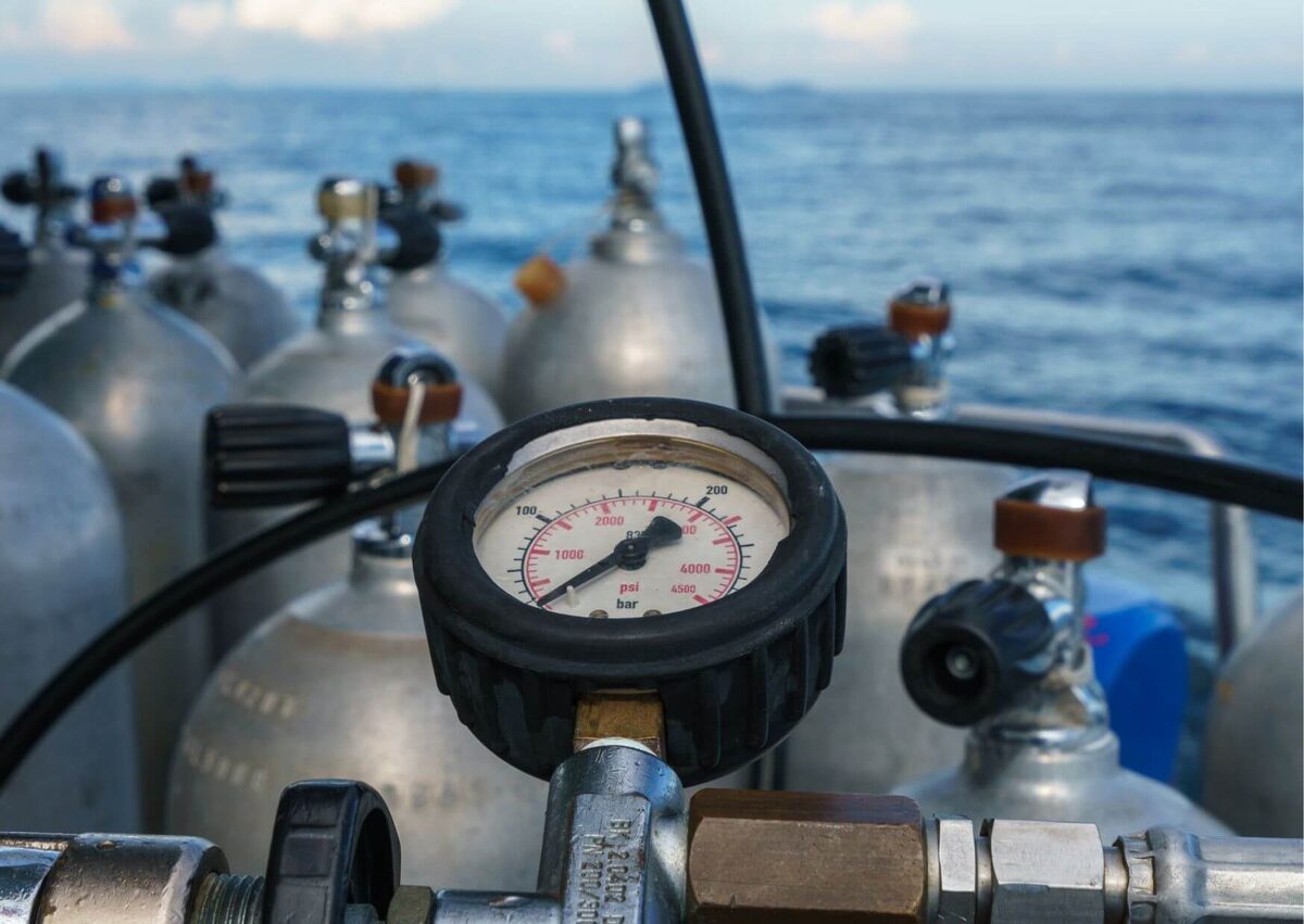 Scuba tanks being filled from the compressor on board