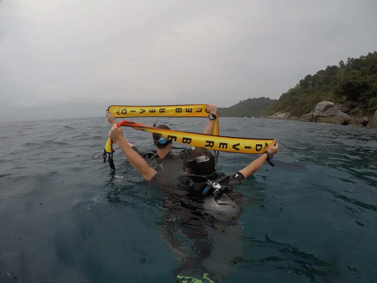 Divers on an Advanced Open Water course drifting over a Phuket reef