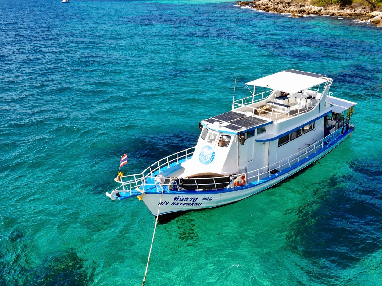 MV Matchanu at anchor over clear turquoise water, seen from above