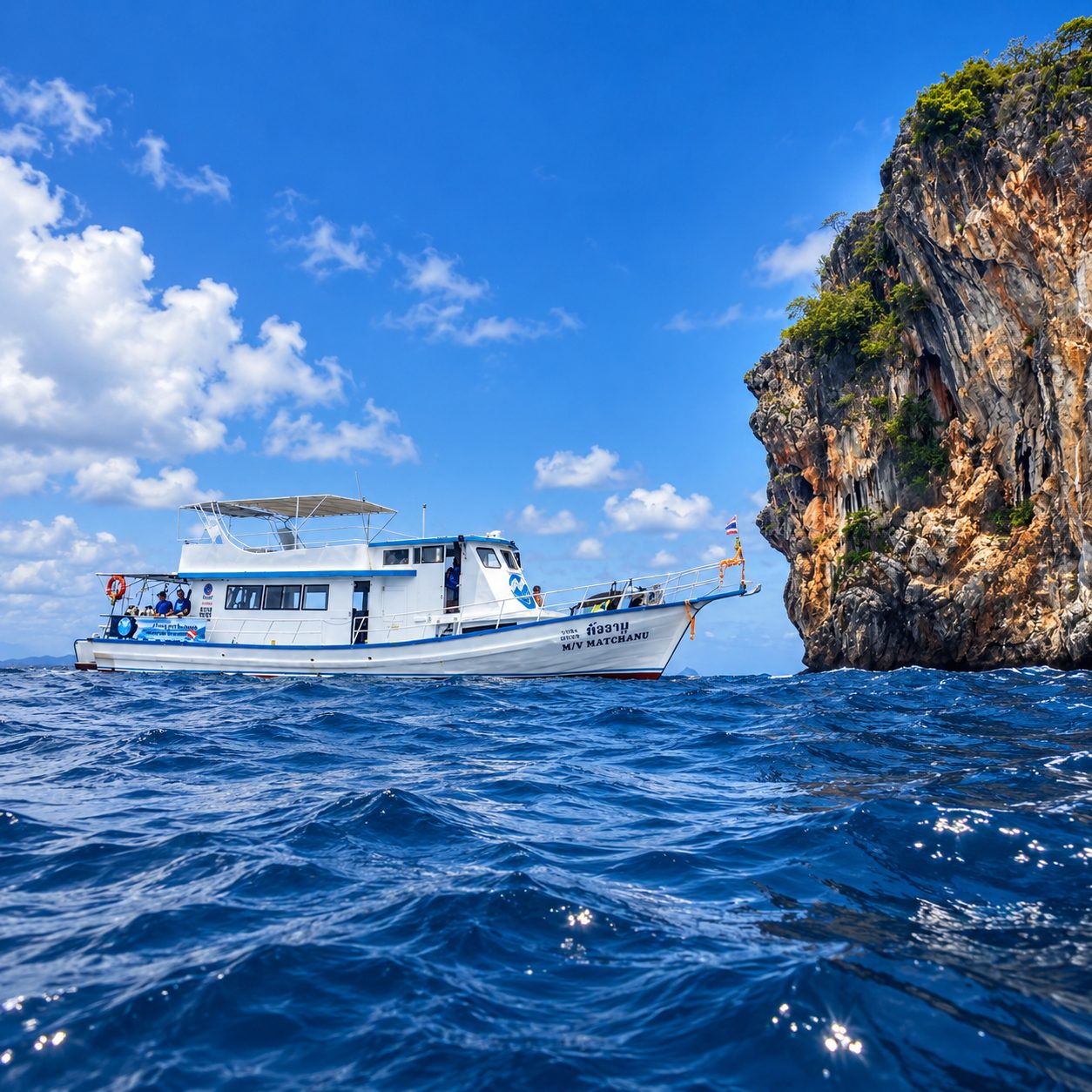 MV Matchanu beside the limestone cliff of Koh Doc Mai