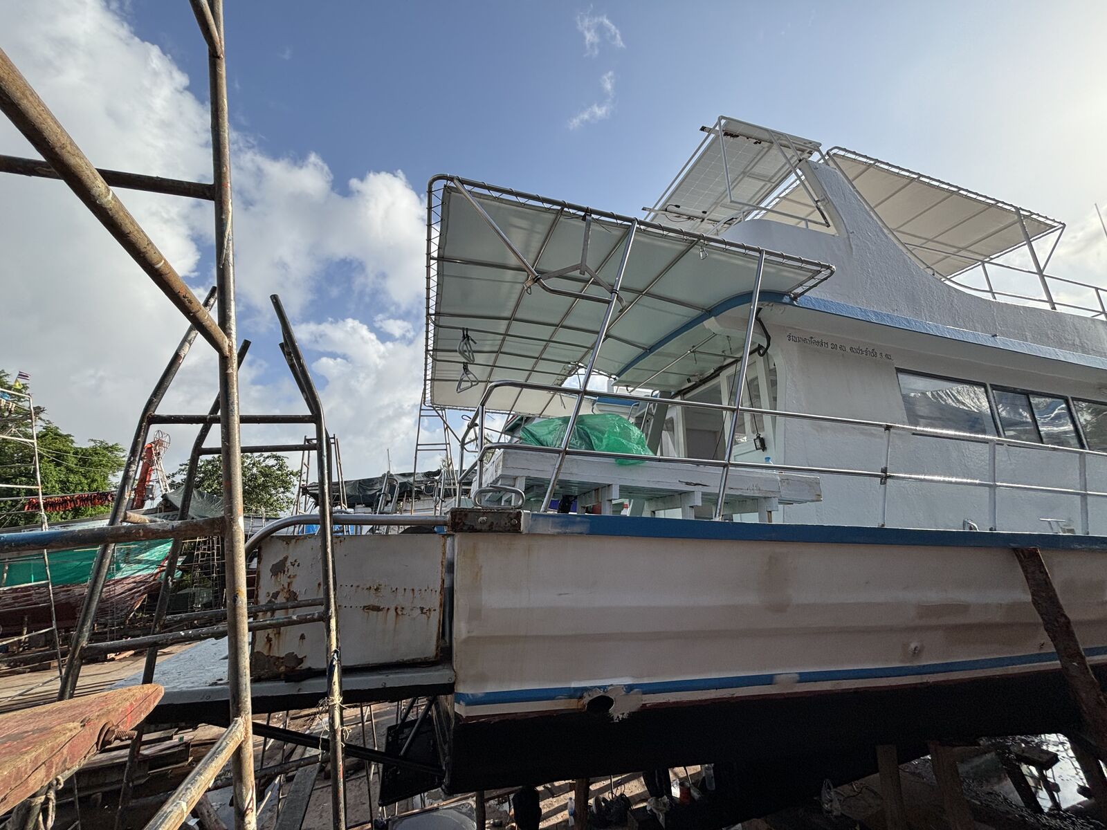 MV Matchanu propped up in the shipyard, bamboo scaffolding along her freshly primed hull
