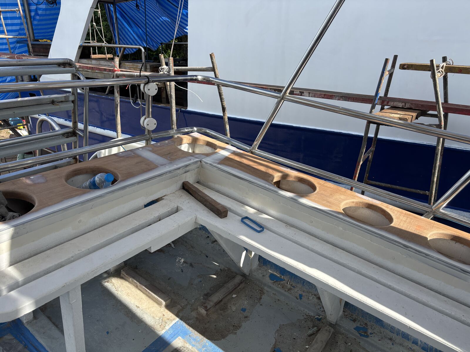The sun-deck table and bench frames stripped back to bare wood for refinishing