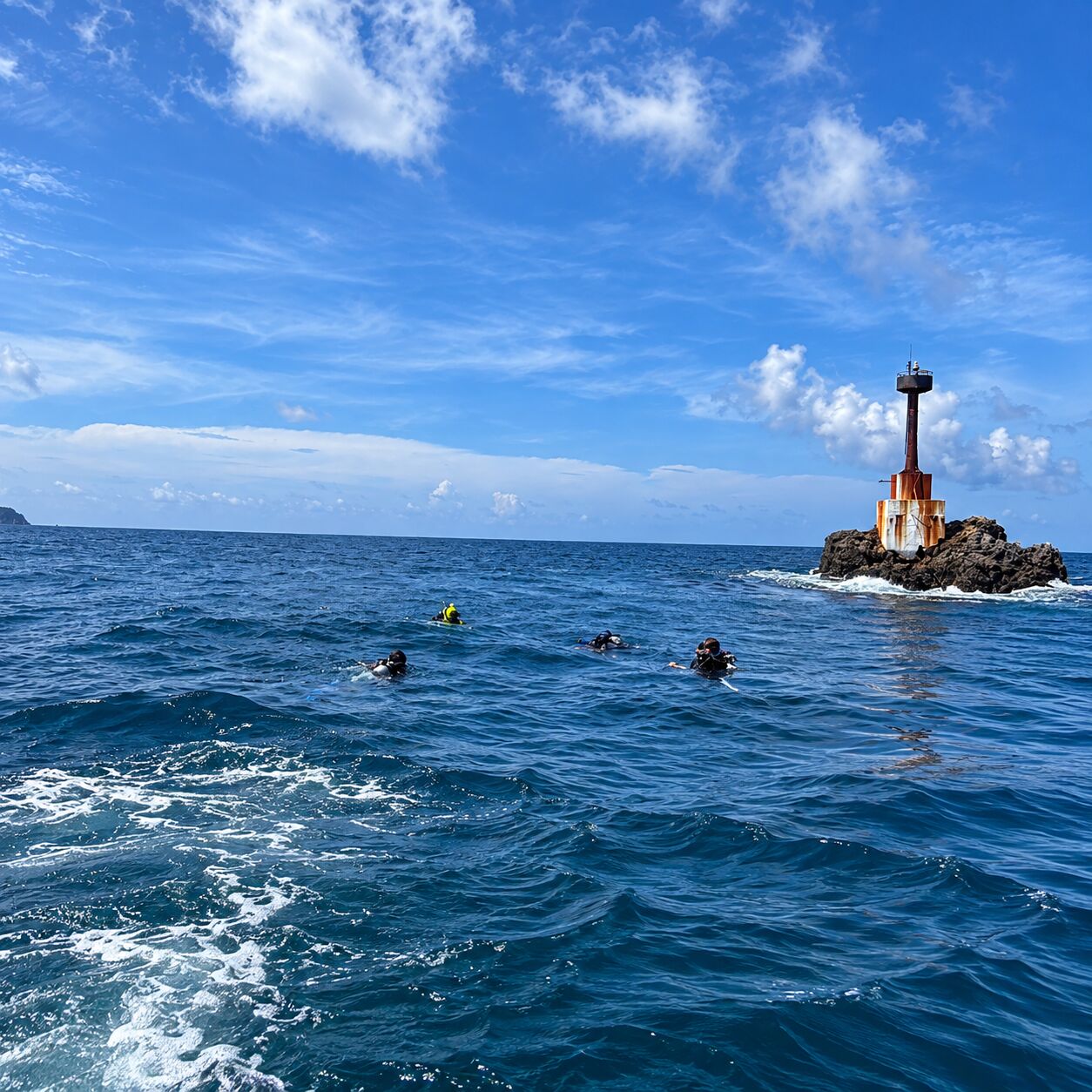The marker at Shark Point, divers on the surface
